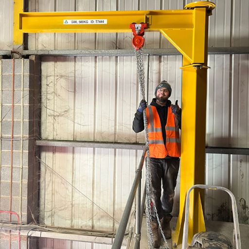 TRI Services employee standing at a custom made lifting jib