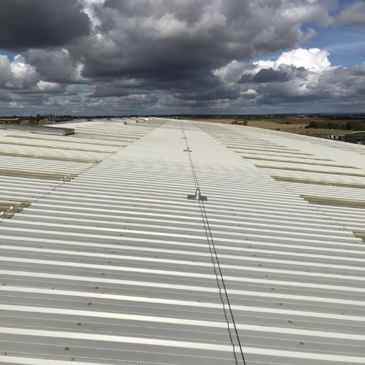 An industrial lifeline fitted on top of a corrugated roof